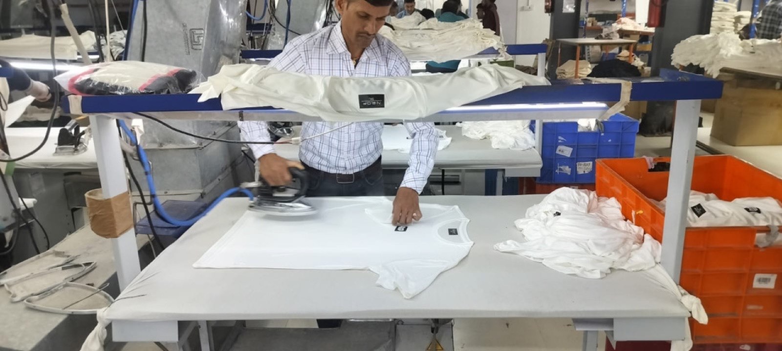 Garment pressing at the Victorious Industries finishing department