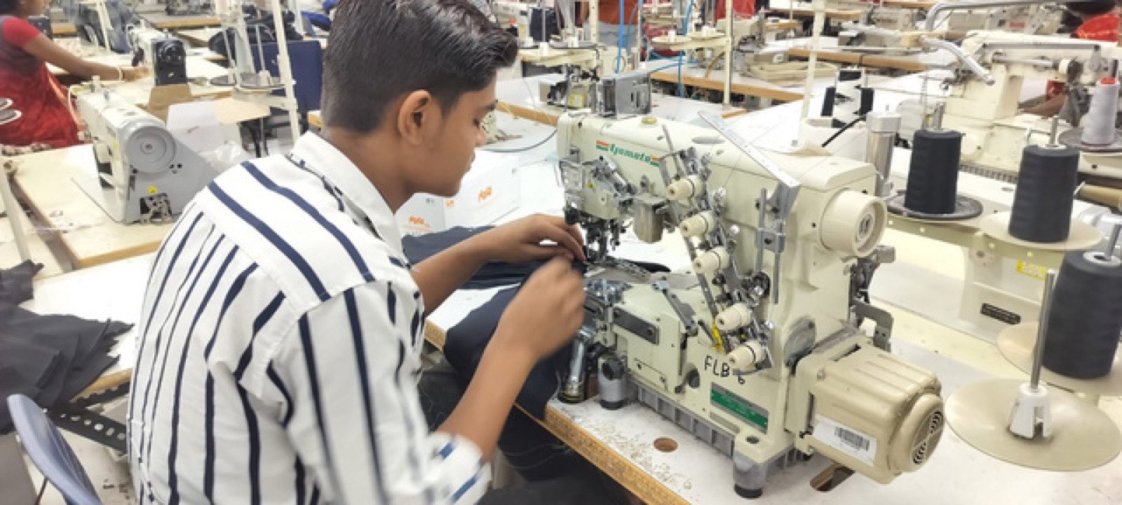 Operator at a coverstitch machine on the Victorious Industries sewing floor